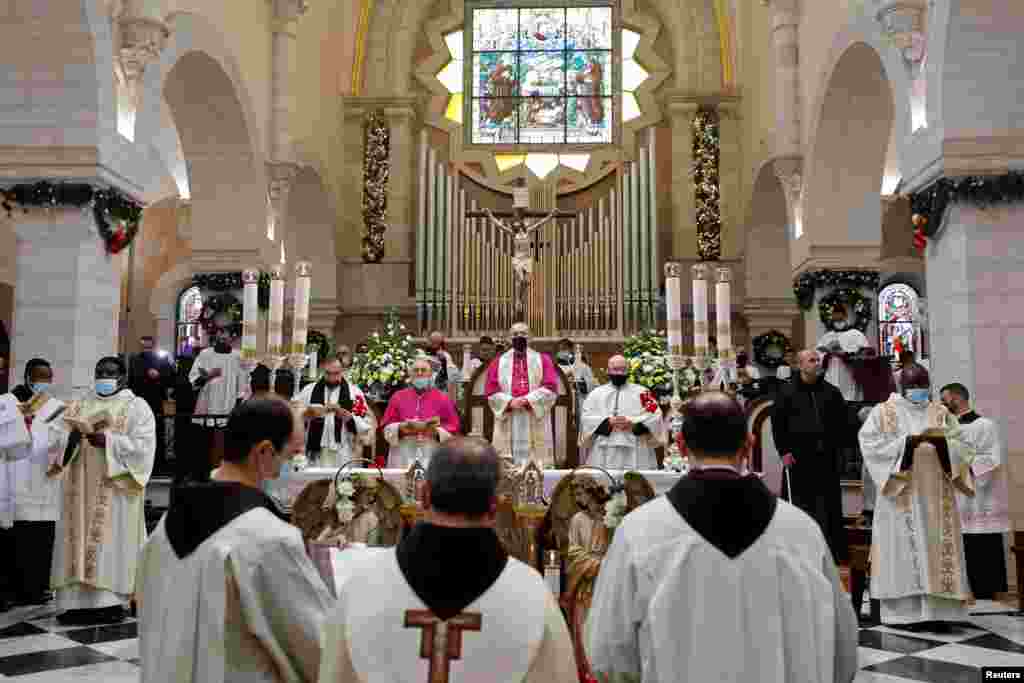 The Latin Patriarch of Jerusalem Pierbattista Pizzaballa holds a Mass in the Church of the Nativity on Christmas eve in Bethlehem, in the Israeli-occupied West Bank.