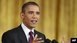 President Barack Obama gestures during a news conference in the East Room of the White House in Washington, June 29, 2011.