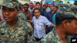 Maldivian President Abdulla Yameen, center, surrounded by his body guards arrives to address his supporters in Male, Feb. 3, 2018.