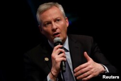 FILE - French Minister for the Economy and Finance Bruno Le Maire speaks at panel on the security-development nexus during IMF spring meetings in Washington, April 20, 2018.