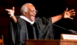 FILE - Archbishop Emeritus Desmond Tutu addresses new University of Oklahoma graduates, during a ceremony after he received a honorary degree, April 25, 2000 in Norman, Oklahoma.