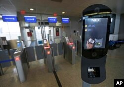 FILE - A U.S. Customs and Border Protection facial recognition device is shown at a United Airlines gate, Wednesday, July 12, 2017, at George Bush Intercontinental Airport, in Houston. (AP Photo/David J. Phillip)