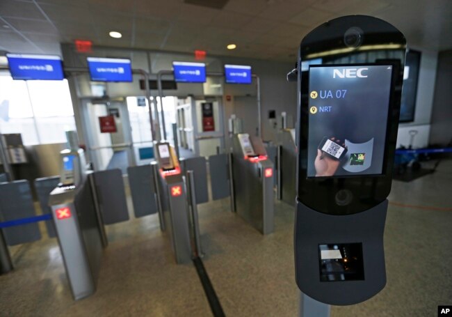 FILE - A U.S. Customs and Border Protection facial recognition device is shown at a United Airlines gate, Wednesday, July 12, 2017, at George Bush Intercontinental Airport, in Houston. (AP Photo/David J. Phillip)