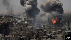 Airstrikes target Islamic State positions on the edge of the Old City a day after Iraq's prime minister declared "total victory" in Mosul, July 11, 2017.