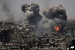 Airstrikes target Islamic State positions on the edge of the Old City a day after Iraq's prime minister declared "total victory" in Mosul, July 11, 2017.