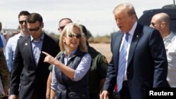 Homeland Security Secretary Kirstjen Nielsen (C) and commissioner for Customs and Border Patrol Kevin McAleenan (L) walk with U.S. President Donald Trump during a visit to a section of the border wall in Calexico California, U.S., April 5, 2019. 