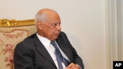 In this image released by the Egyptian Presidency, Hazem el-Beblawi meets with interim President Adly Mansour, unseen, in Cairo, July 9, 2013.