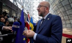 FILE - Belgian Prime Minister Charles Michel speaks with the media as he arrives for an EU summit in Brussels on Saturday, April 29, 2017.