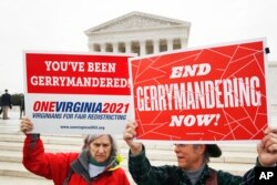 FILE - Activists from the state of Virginia rally against gerrymandering, in front of the U.S. Supreme Court, in Washington, March 28, 2018.