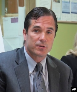 FILE - Nick Lyon, Michigan Health and Human Services director , June 5, 2017. Lyon has been charged with involuntary manslaughter in a criminal investigation of Flint's lead-contaminated water.