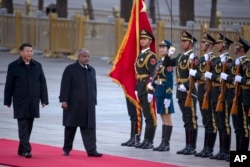 FILE - Djibouti's President Ismail Omar Guelleh (2nd-L) walks with Chinese President Xi Jinping during a welcome ceremony held outside the Great Hall of the People in Beijing, China, Nov. 23, 2017.