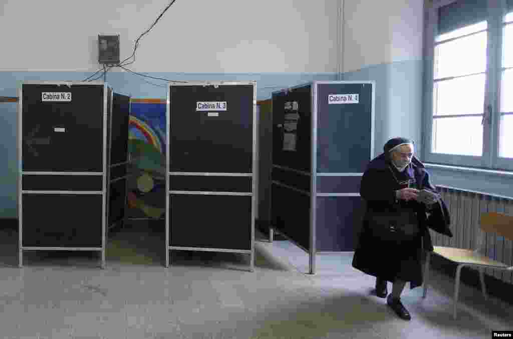 A nun casts her vote in a polling station in Rome, Feb. 24, 2013. 