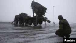 German troops beside a Patriot missile battery during a media rehearsal, Warbelow, Dec. 18, 2012.