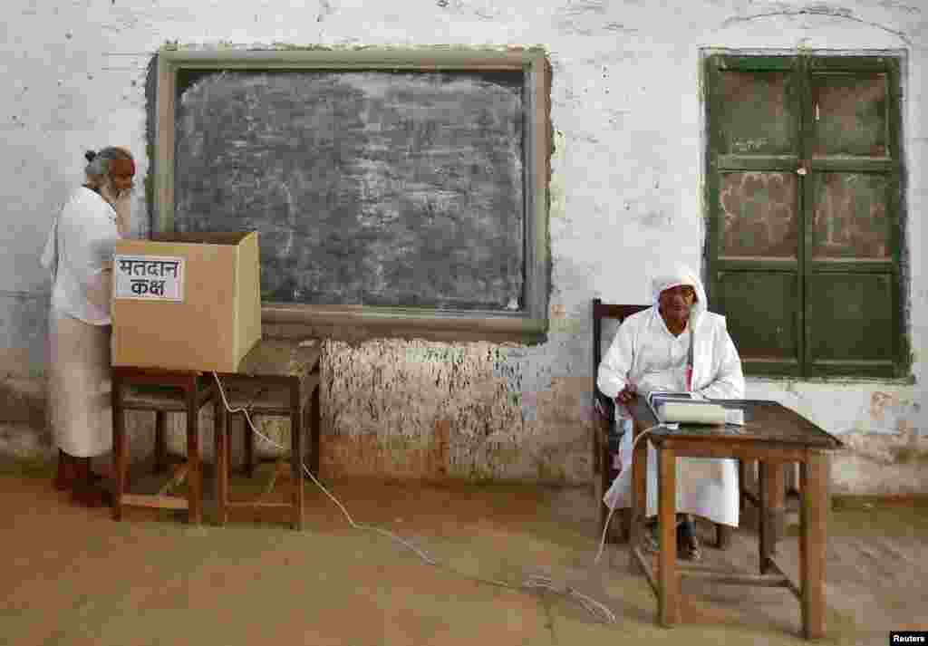 A sadhu (Hindu holy man) casts his vote at a polling station at Ayodhya in the northern Indian state of Uttar Pradesh.