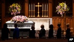 Members of the public walk past the casket of former first lady Barbara Bush at St. Martin's church, April 20, 2018, in Houston.