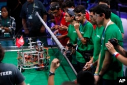 Team Iran, in green, competes in the FIRST Global Robotics Challenge, July 18, 2017, in Washington.