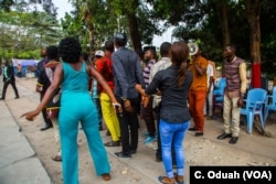 Singers and dancers gather at the ruling party's office grounds in Kinshasa, as they do nearly every day, to energize the public with lively music.