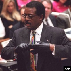 Defense lawyer Johnnie Cochran put on a pair of gloves to demonstrate a point to the jury in the O.J. Simpson murder trial in 1995. A bloody glove had been found at the murder scene, and another outside Simpson's house.