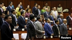 Members of parliament attend a plenary session at the Cambodia National Assembly in Central Phnom Penh, December 16, 2015. 