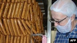 Turtle Island Foods founder Seth Tibbott examines freshly made Tofurky Italian sausages