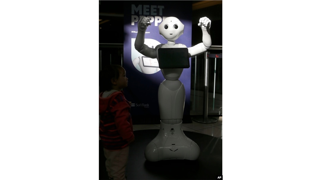 Kids are fascinated by 4-foot-tall Pepper, who can chirp, dance and pose for selfies, Dec. 22, 2016.