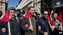 Members of pro-communist union PAME shout slogans during a protest in Athens, February 20, 2013. 