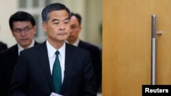 FILE - Hong Kong Chief Executive Leung Chun-ying arrives at a news conference which was held as part of the National People's Congress, the country's parliament, in Beijing, March 6, 2015.