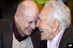 Comedian Don Rickles (left) laughs with actor Kirk Douglas at Douglas' 100th birthday party at the Beverly Hills Hotel, Dec. 9. 2016, in Beverly Hills, Calif.