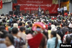 FILE - Myanmar pro-democracy leader Aung San Suu Kyi gives a speech on voter education at the Hopong township in Shan state, Myanmar, Sept. 6, 2015.