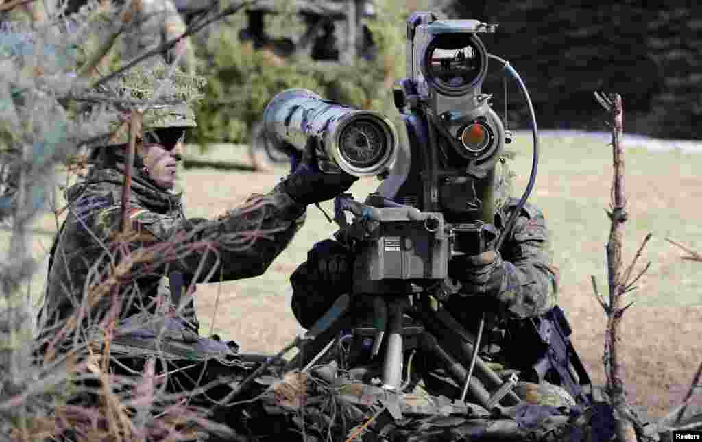 German soldiers take position with a MILAN anti-tank rocket launcher during a media day at the barracks in Marienberg.