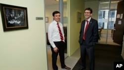 Washington state Solicitor General Noah Purcell (left) and Attorney General Bob Ferguson pose for a photo next to their adjoining offices in Seattle.