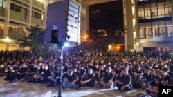 FILE - Hundreds of staff members and students from the University of Hong Kong, in black, stage a demonstration on the campus in Hong Kong, Oct. 9, 2015.