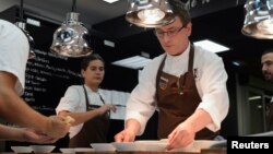 FILE - Basque chef Andoni Aduriz (C) prepares a dish in the kitchen at his restaurant Mugaritz in Renteria, near San Sebastian, Spain, June 3, 2012. 