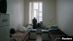 FILE - A patient is seen in a ward at the state-run Lavra clinic, Ukraine's main HIV treatment centre, in Kiev, Sept. 12, 2013. 