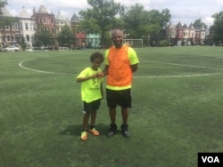 DC Scores Coach Popsie Lewis (right) with one of his players at Tubman Elementary School in Washington DC. (Photo by J. Nazar/VOA)