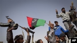 Rebels jubilate after taking the city of Ajdabiya, south of Benghazi, eastern Libya, March 26, 2011