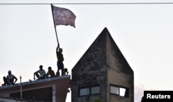 Inmates are pictured on roof after a new uprising broke out at Alcacuz prison in Natal, Rio Grande do Norte state, Brazil, Jan. 16, 2017.