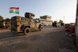 Iraqi forces and Kurdish Peshmerga fighters take part in an intensive security deployment after Islamic State militants took it over the previous day in Luhaiban village in Kirkuk, Iraq, Dec. 6,2021.