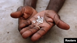 An illegal diamond dealer from Zimbabwe displays diamonds for sale in Manica, near the border with Zimbabwe, September 19, 2010.