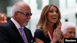 FILE - Celine Dion, who with husband Rene Angelil received Order of Canada awards last year, is suspending her singing career to focus on family and health.