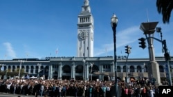 Google employees fill Harry Bridges Plaza in front of the Ferry Building during a walkout, Nov. 1, 2018, in San Francisco. Hundreds of Google employees around the world briefly walked off the job in a protest against what they said is the tech company's mishandling of sexual misconduct allegations against executives.