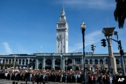 FILE - Google employees fill Harry Bridges Plaza in front of the Ferry Building during a walkout, Nov. 1, 2018, in San Francisco.