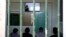 Prisoners sitting in a room while they watch a recorded music lesson in Avlona prison, north of Athens, Greece. (AP Photo/Thanassis Stavrakis)