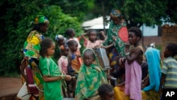 Muslim children gather at a water pump outside the mosque at PK12 in Bangui, Central African Republic, Thursday April 10, 2014.