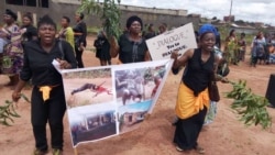 FILE - Women protest holding up a poster with images of atrocities committed in an ongoing conflict between government forces and armed separatists, in Bamenda, Cameroon, Sept. 7, 2018. (Moki Edwin Kindzeka/VOA)