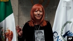 FILE - Wearing a photo of her brother — who went missing in 1975 — around her neck, Rosario Piedra Ibarra speaks during a press conference in Mexico City, Nov. 21, 2019. 