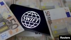 Swift code bank logo is displayed on an iPhone 6s on top of Euro banknotes in this picture illustration made in Zenica, Bosnia and Herzegovina on January 26, 2016.