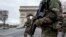 French soldiers cross the Champs Elysees avenue passing the Arc de Triomphe in Paris, Nov. 16, 2015.