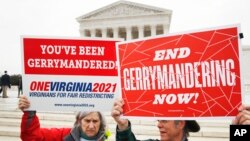 FILE - Activists from the state of Virginia rally against gerrymandering, in front of the U.S. Supreme Court, in Washington, March 28, 2018.