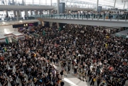 FILE - Anti-extradition bill protesters attend a mass demonstration at Hong Kong International Airport, Aug. 12, 2019.
